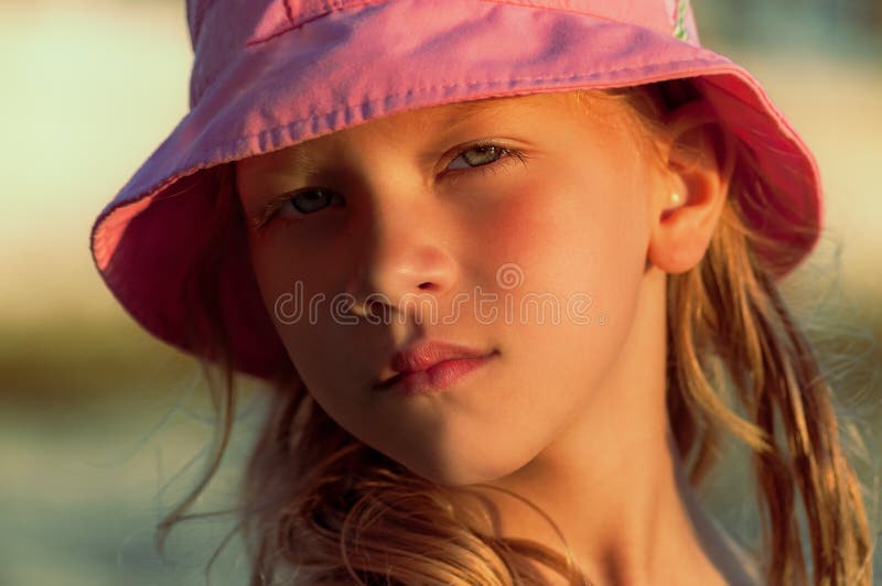 Portrait of a cute little girl in a pink panama stock photo