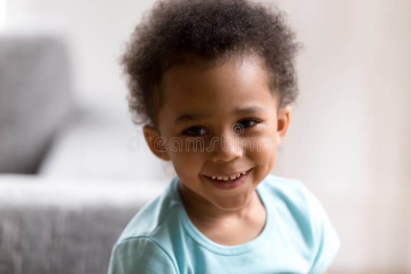 Portrait of cute mixed race toddler boy smiling