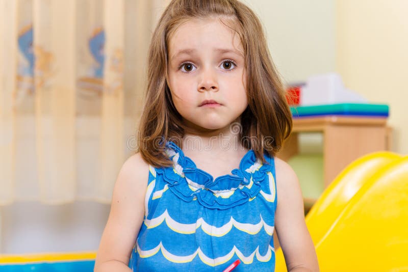 Portrait of cute serious little girl royalty free stock image