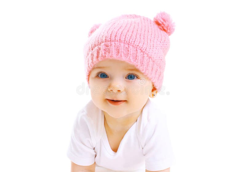 Portrait cute smiling baby in knitted pink hat on white royalty free stock image