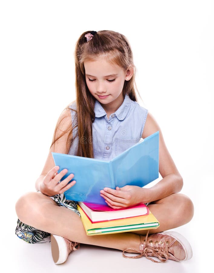 Portrait of cute smiling happy little school girl child teenager sitting on a floor and reading the book isolated royalty free stock photos Portrait of cute smiling happy little school girl child teenager sitting on a floor and reading the book isolated royalty free stock photos