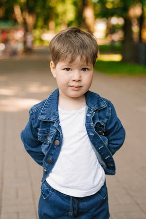 Portrait Of A Cute Three year old Boy In Jeans In Summer In The Park 