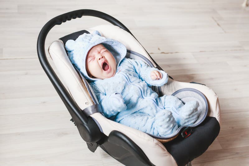 Portrait of cute yawning mixed race baby boy sitting in car seat. Child transportation safety stock photo Portrait of cute yawning mixed race baby boy sitting in car seat. Child transportation safety stock photo