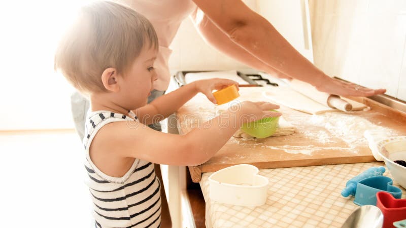 Portrait of Cute 3 Years Old Toddler Boy Cooking Cookies with Mother