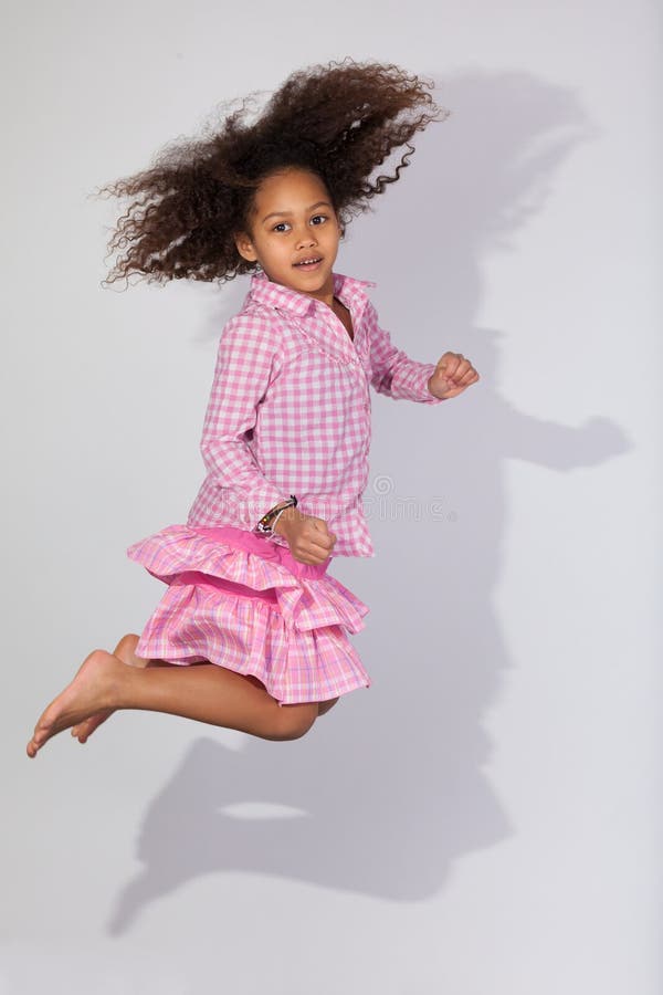 Portrait of Young African American girl jumping. Portrait of cute Young African American girl jumping, over gray background royalty free stock photos Portrait of Young African American girl jumping. Portrait of cute Young African American girl jumping, over gray background royalty free stock photos