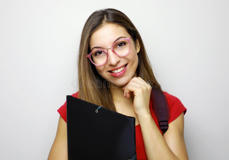 Portrait of cute young student girl with glasses, folder and backpack royalty free stock photography Portrait of cute young student girl with glasses, folder and backpack royalty free stock photography
