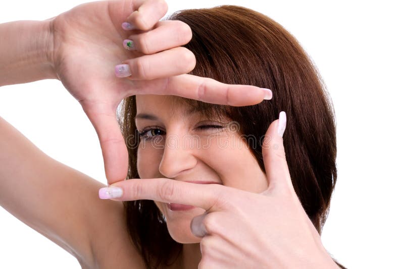 Portrait of cute young woman creates a frame with her hands