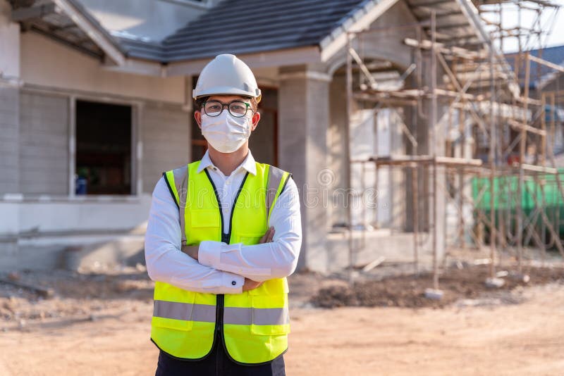 Portrait of Architect wearing a mask on a building construction site, Homebuilding Ideas and Prevention of Coronavirus Disease. Portrait of Architect wearing a mask on a building construction site, Homebuilding Ideas and Prevention of Coronavirus Disease.