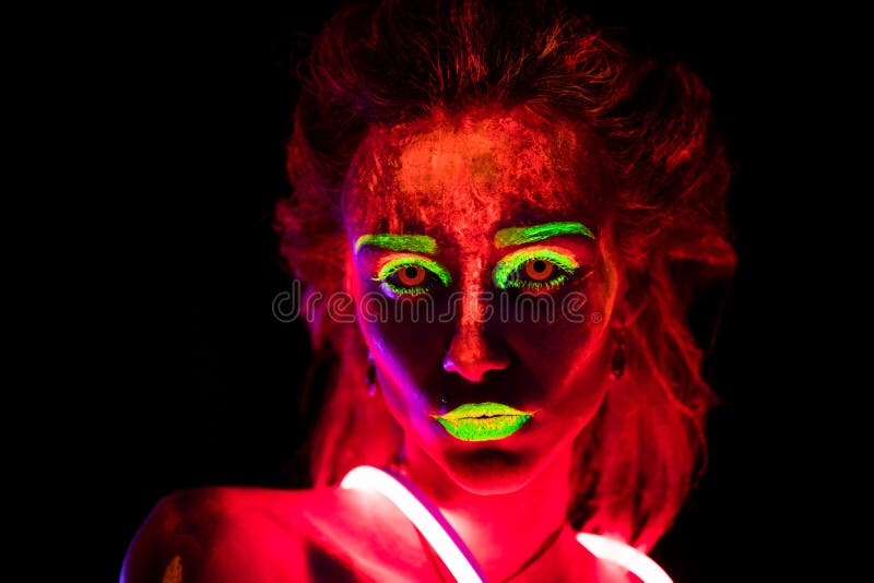 Portrait d'une belle jeune fille sexy en néon prêté avec la peinture ultra-violette sur son corps Jolie femme avec rougeoyer image libre de droits Portrait d'une belle jeune fille sexy en néon prêté avec la peinture ultra-violette sur son corps Jolie femme avec rougeoyer image libre de droits