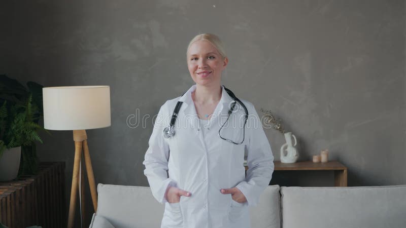 Portrait d'une jeune belle femme médecin en manteau blanc
