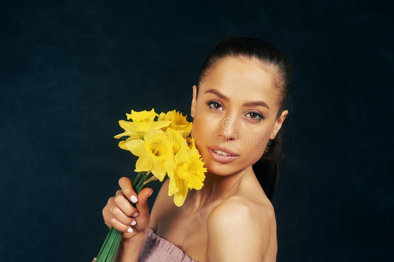 Portrait d'une jeune belle fille avec des fleurs dans le studio image stock Portrait d'une jeune belle fille avec des fleurs dans le studio image stock