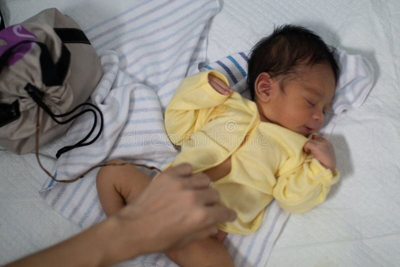 A portrait of a 42-day-old boy born in a lotus birth. Unlike babies in general, the baby`s umbilical cord is left to join with th royalty free stock images A portrait of a 42-day-old boy born in a lotus birth. Unlike babies in general, the baby`s umbilical cord is left to join with th royalty free stock images