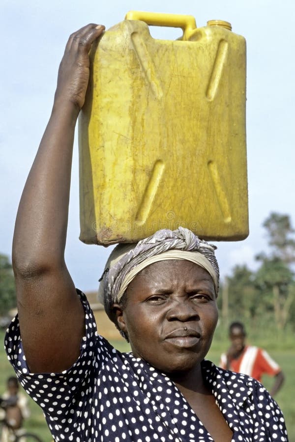 Portrait de femme ougandaise avec le jerrycan sur la tête photo libre de droits Portrait de femme ougandaise avec le jerrycan sur la tête photo libre de droits