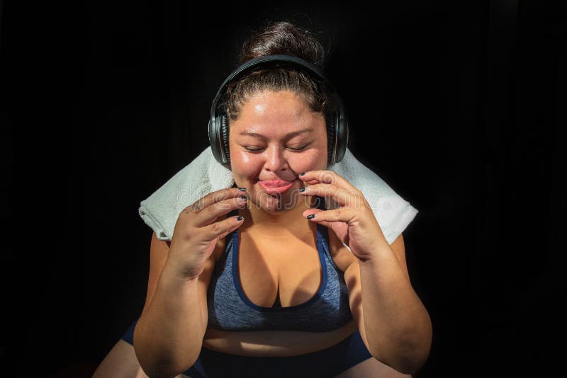 Portrait de jeune femme obèse écouter de la musique prête à commencer la séance d'entraînement de remise en forme, imaginant la n photographie stock