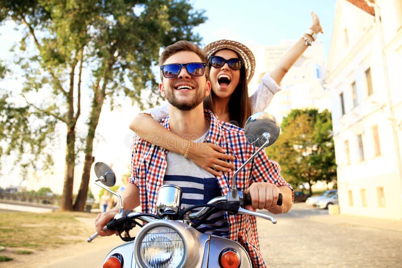 Portrait de jeunes couples heureux sur le scooter appréciant le voyage par la route photos stock Portrait de jeunes couples heureux sur le scooter appréciant le voyage par la route photos stock