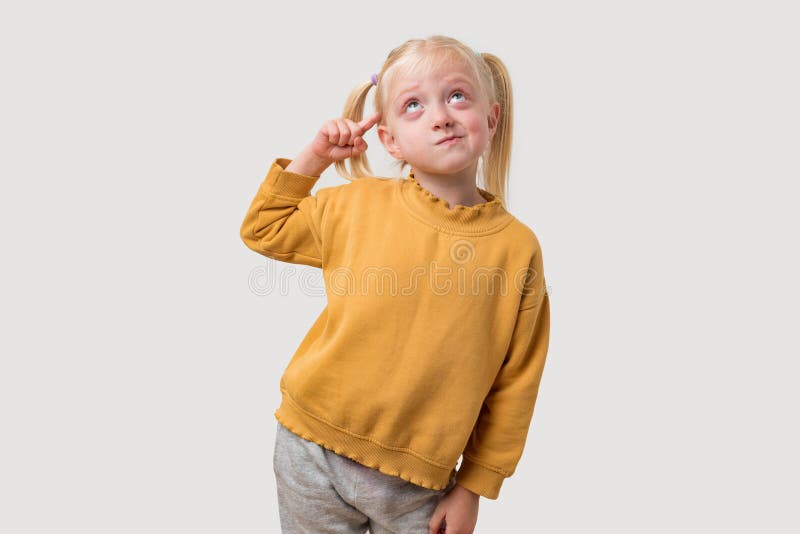 Portrait de petite fille blonde mignonne avec queue de cheval en chandail jaune image libre de droits