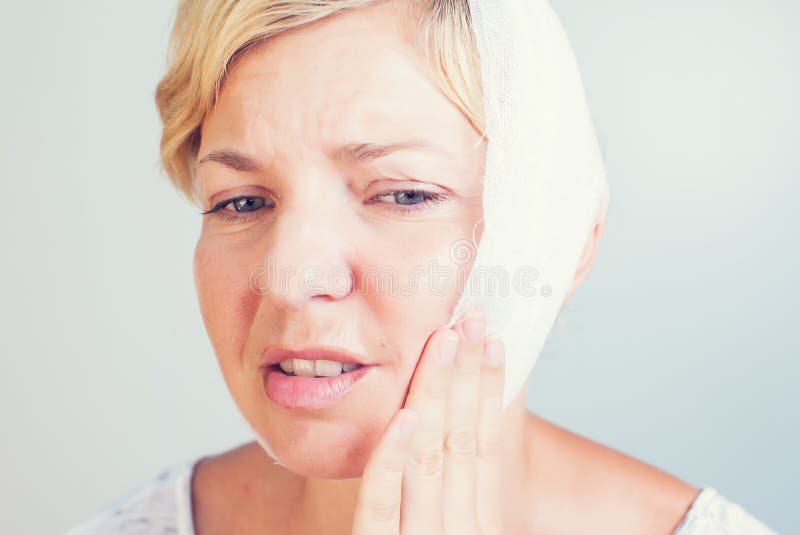 Closeup portrait of young woman achy girl suffering from terrible tooth pain on white background. Closeup portrait of young woman achy girl suffering from terrible tooth pain on white background