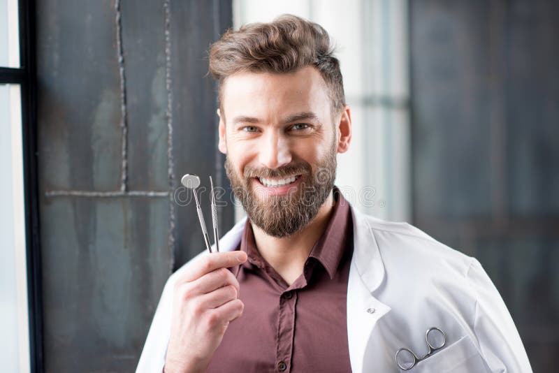 Portrait of a dentist near the window stock photos Portrait of a dentist near the window stock photos
