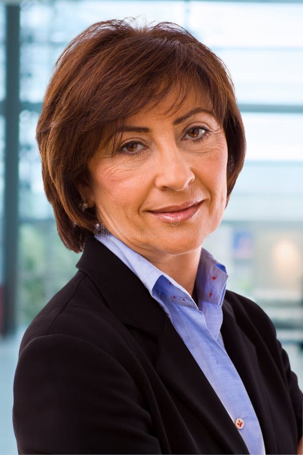 Portrait of senior businesswoman at office lobby. Portrait of senior businesswoman at office lobby.