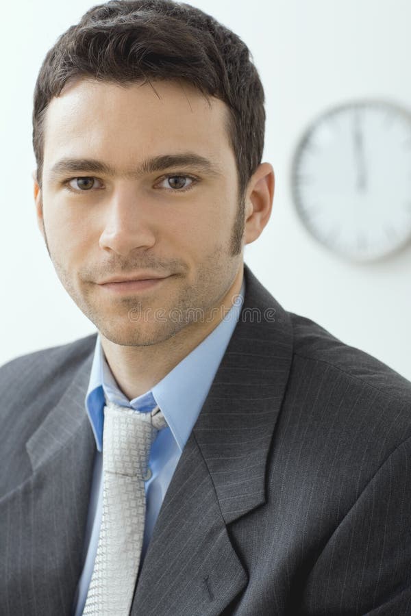 Closeup portrait of businessman wearing grey suit and blue shirt, serious look. Closeup portrait of businessman wearing grey suit and blue shirt, serious look.