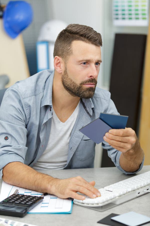 Portrait designers holding color swatch in office royalty free stock photo