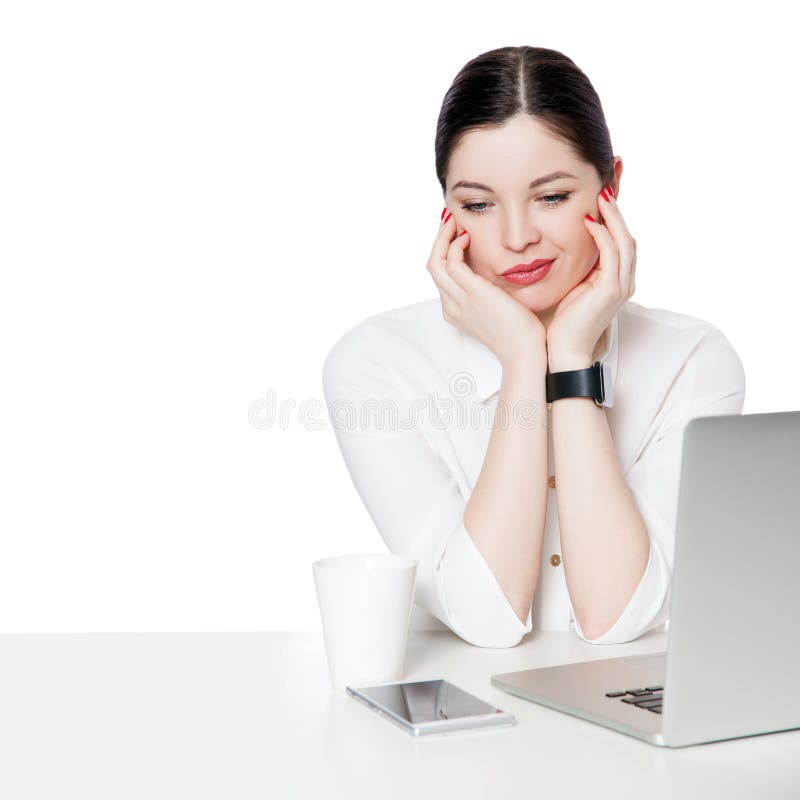 Portrait of dissatisfied or sad brunette businesswoman in white shirt sitting with laptop touching her face and thinking or stock photography Portrait of dissatisfied or sad brunette businesswoman in white shirt sitting with laptop touching her face and thinking or stock photography