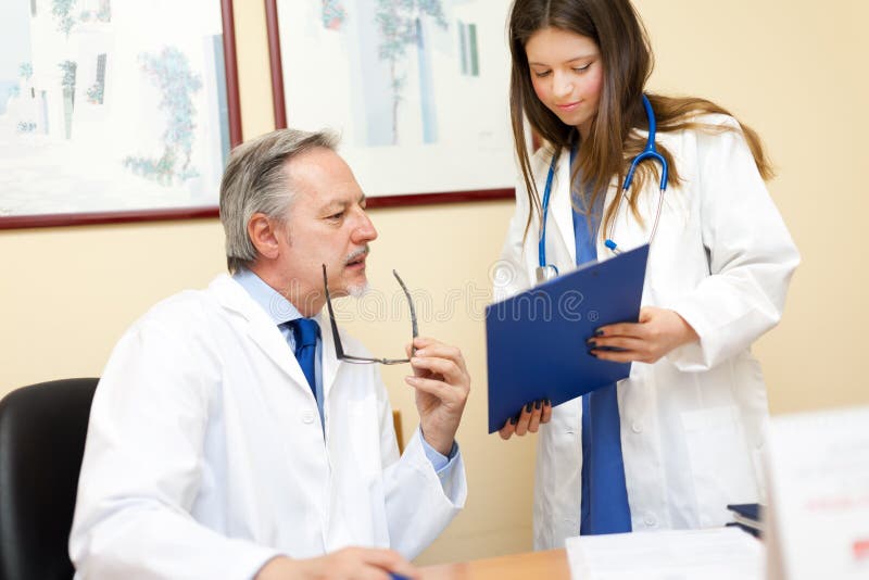 Portrait of a doctor and his assistant stock images Portrait of a doctor and his assistant stock images