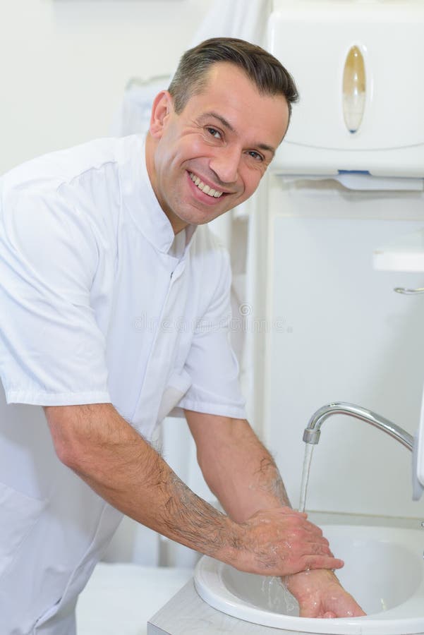 Portrait doctor washing hands