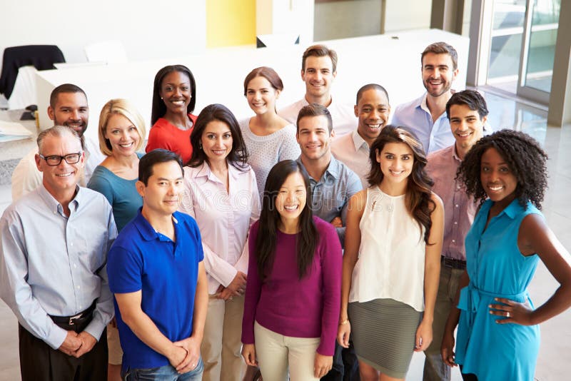 Portrait Of Multi-Cultural Office Staff Standing In Lobby Smiling To Smiling To Camera. Portrait Of Multi-Cultural Office Staff Standing In Lobby Smiling To Smiling To Camera