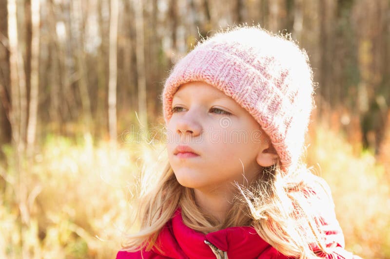 portrait of an eight-year-old girl in an autumn park on a sunny day stock photo