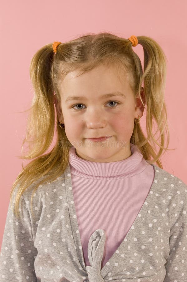 Portrait of a young blond girl on pink background. Portrait of a young blond girl on pink background