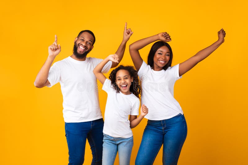 Portrait of emotional black family dancing at studio