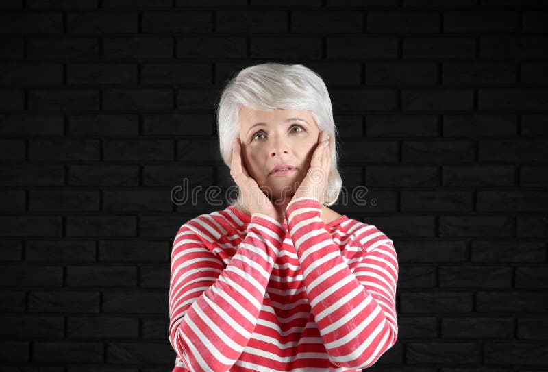 Portrait of emotional mature woman on dark background royalty free stock photography Portrait of emotional mature woman on dark background royalty free stock photography