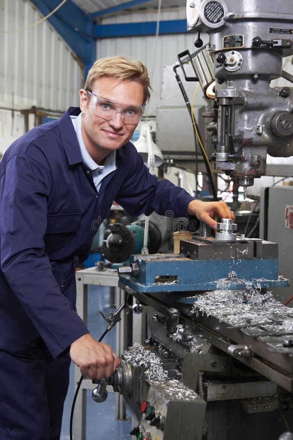 Portrait Of Engineer Using Drill In Factory royalty free stock images
