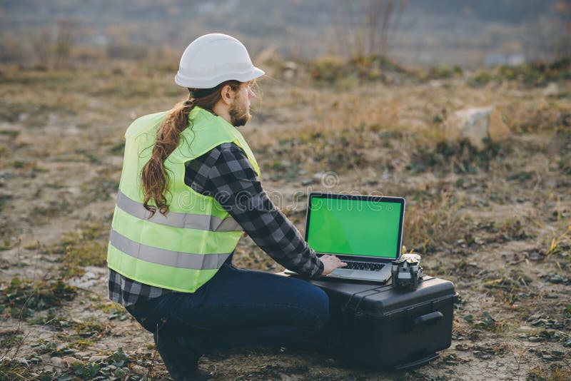 Construction worker, caucasian man working with safety helmet and using using laptop with chroma key display stock image Construction worker, caucasian man working with safety helmet and using using laptop with chroma key display stock image