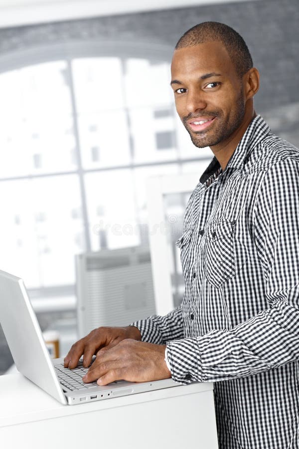 Portrait of ethnic office worker with laptop royalty free stock photos