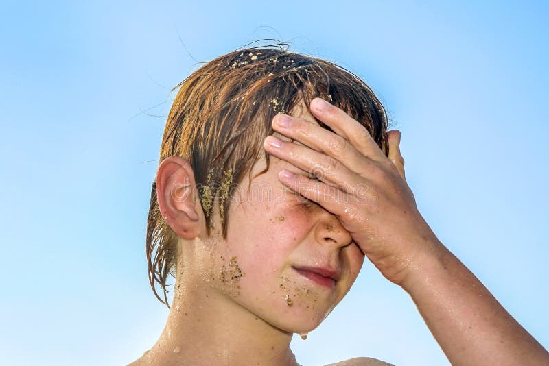 Portrait of exhausted boy at the beach