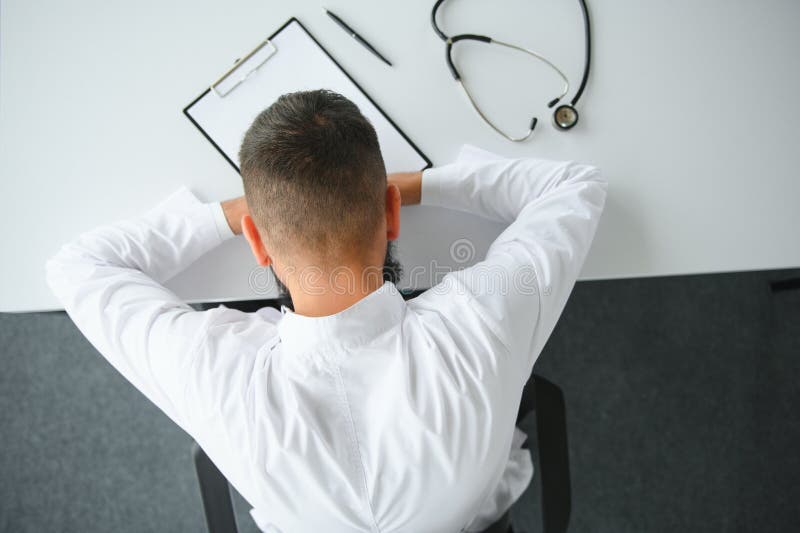 Portrait Of Exhausted Tired Young Arab Male Doctor After Hard Day At