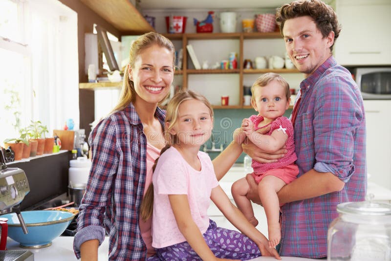 Portrait Of Family Cooking Meal In Kitchen Together stock photo Portrait Of Family Cooking Meal In Kitchen Together stock photo