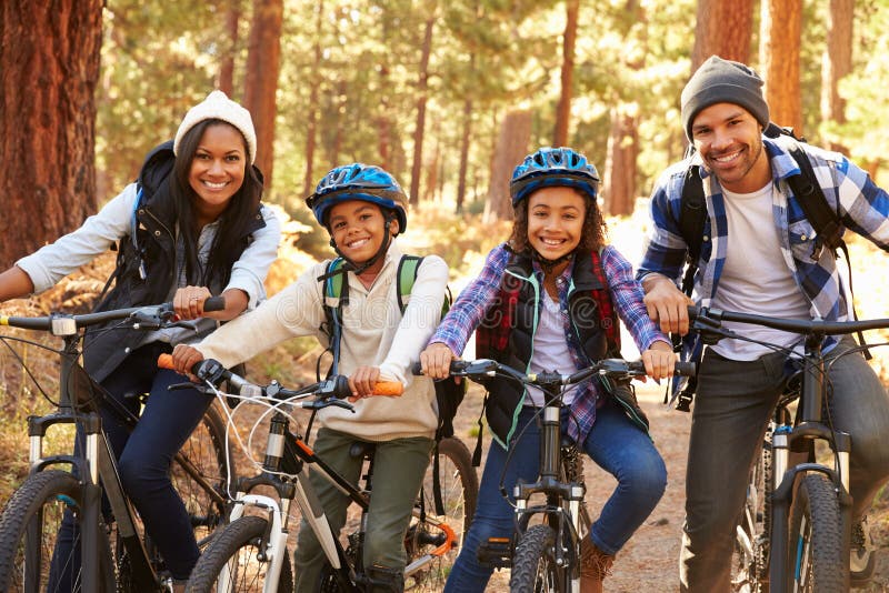 Portrait Of Family Cycling Through Fall Woodland royalty free stock photos Portrait Of Family Cycling Through Fall Woodland royalty free stock photos