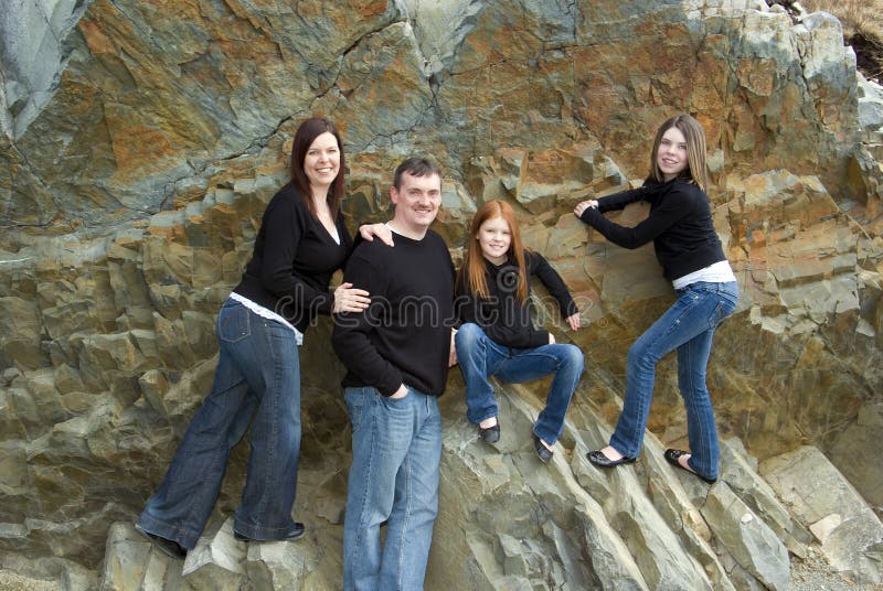 Portrait of parents, tween and teen girls with cliff background that was once an ocean floor. Portrait of parents, tween and teen girls with cliff background that was once an ocean floor
