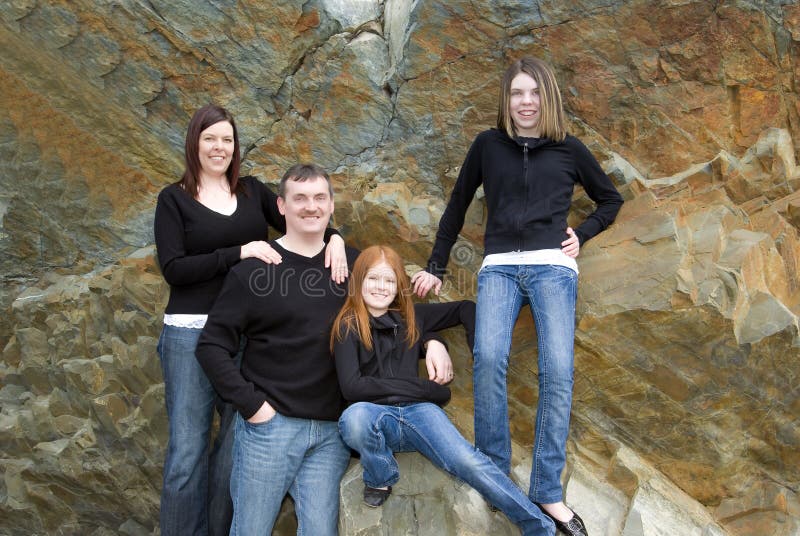 Portrait of parents, tween and teen girls with cliff background that was once an ocean floor. Portrait of parents, tween and teen girls with cliff background that was once an ocean floor