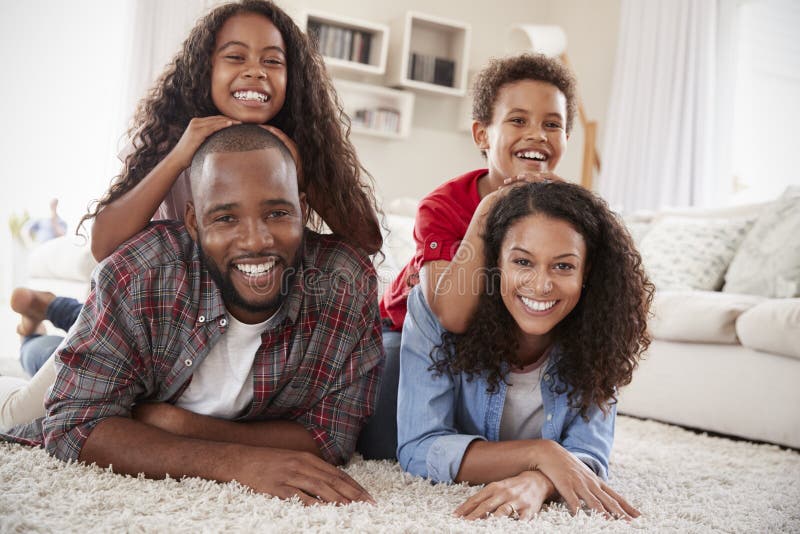 Portrait Of Family Lying On Rug In Lounge At Home royalty free stock images Portrait Of Family Lying On Rug In Lounge At Home royalty free stock images