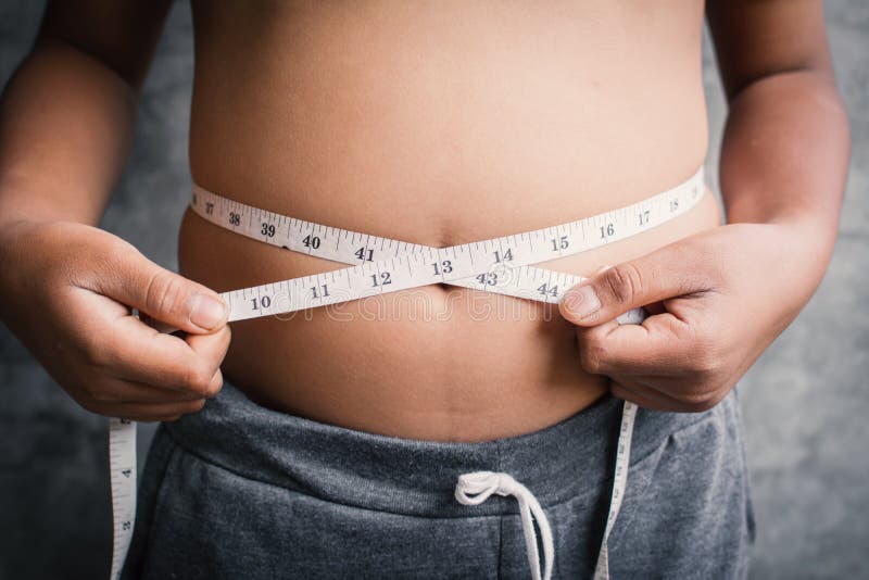 Portrait fat boy measuring tape of stomach stock photos Portrait fat boy measuring tape of stomach stock photos