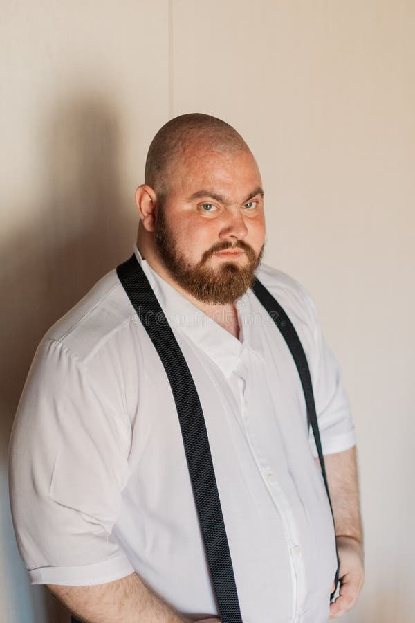 Portrait of a Fat Man with Suspenders on His Pants. Stock Photo Image