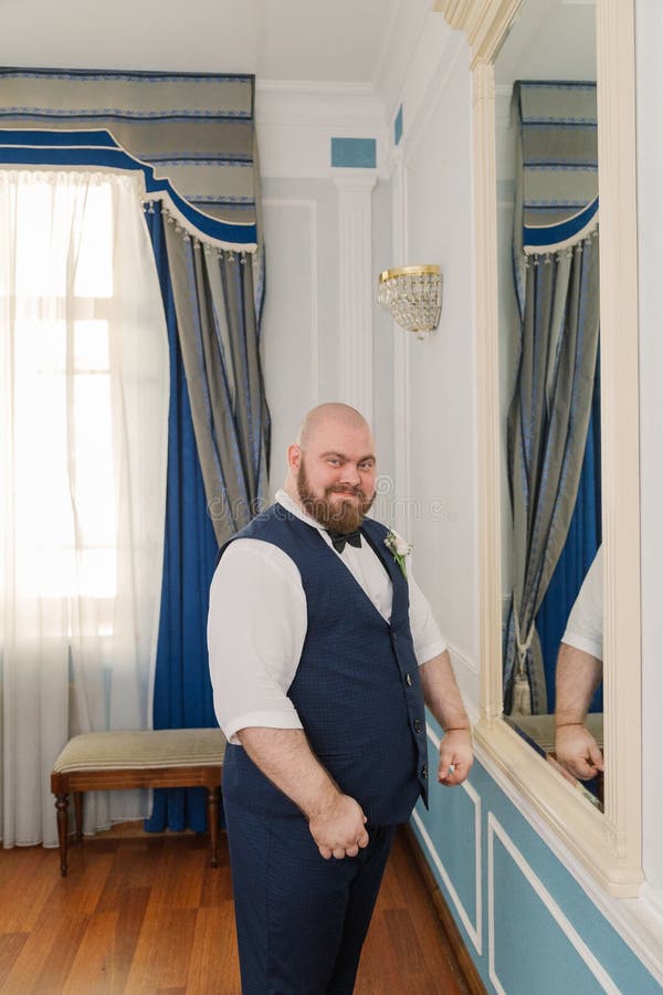 Portrait of a Fat Man with Suspenders on His Pants. Stock Photo Image