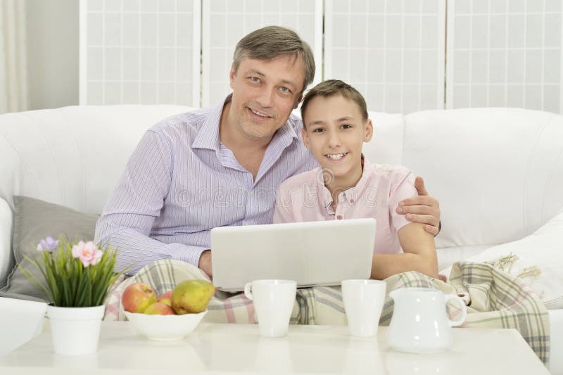 Portrait of father and son with laptop royalty free stock photos Portrait of father and son with laptop royalty free stock photos
