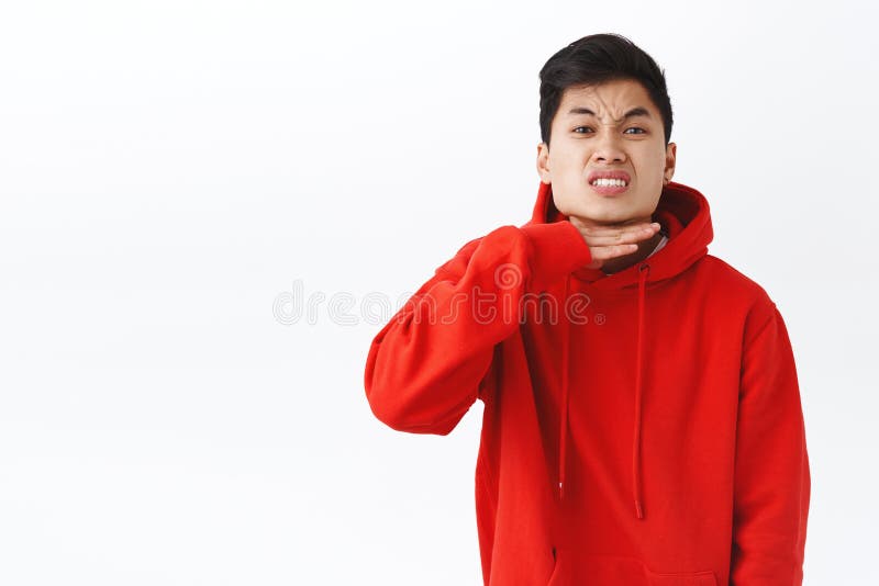 Portrait of fed up, pissed-off asian guy being angry, annoyed with someone, showing cut throat gesture as if head enough