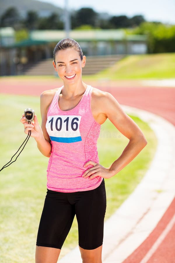 Portrait of Female Athlete Showing Stopwatch Stock Photo - Image of ...