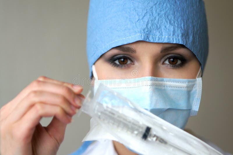 Portrait of a female doctor holding a syringe